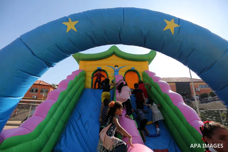 Palestinian children play at an amusement park on the third day of Eid al-Fitr holiday which marks the end of the Muslim holy month of Ramadan, in Gaza City on June 27, 2017. Photo by Ashraf Amra