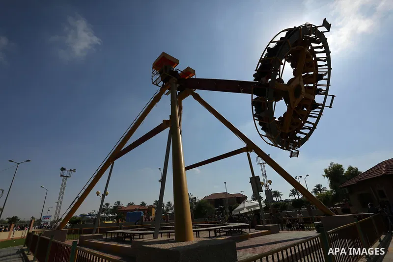 Palestinians take a ride at an amusement park on the third day of Eid al-Fitr holiday which marks the end of the Muslim holy month of Ramadan, in Gaza City on June 27, 2017. Photo by Ashraf Amra