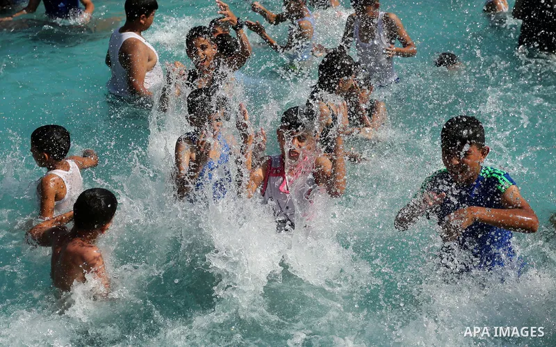 Palestinian children swim in a pool at an amusement park on the third day of Eid al-Fitr holiday which marks the end of the Muslim holy month of Ramadan, in Gaza City on June 27, 2017. Photo by Ashraf Amra