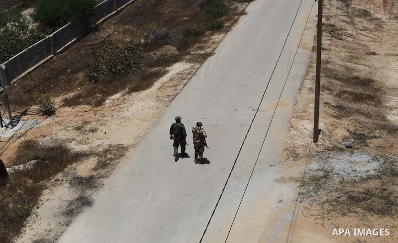 Members of Palestinian security forces loyal to Hamas patrol a section of the border with Egypt, in the southern Gaza strip town of Rafah on June 28, 2017, with the Egyptian side of the border appearing on the left. Hama...