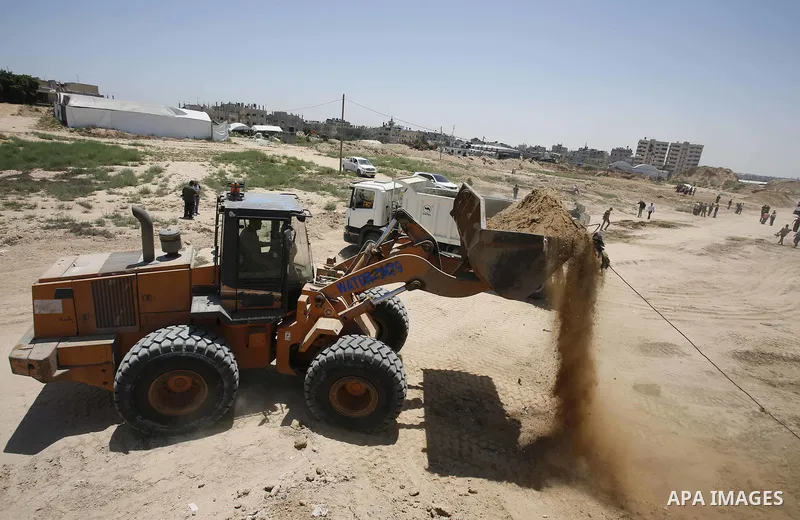 Palestinian bulldozers clear an area as Hamas begins creating a large buffer zone on the border with Egypt in the southern Gaza strip town of Rafah, on June 28, 2017. The buffer zone is expected to extend for a length of...