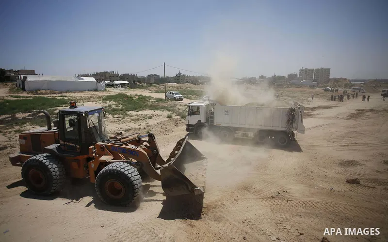 Palestinian bulldozers clear an area as Hamas begins creating a large buffer zone on the border with Egypt in the southern Gaza strip town of Rafah, on June 28, 2017. The buffer zone is expected to extend for a length of...