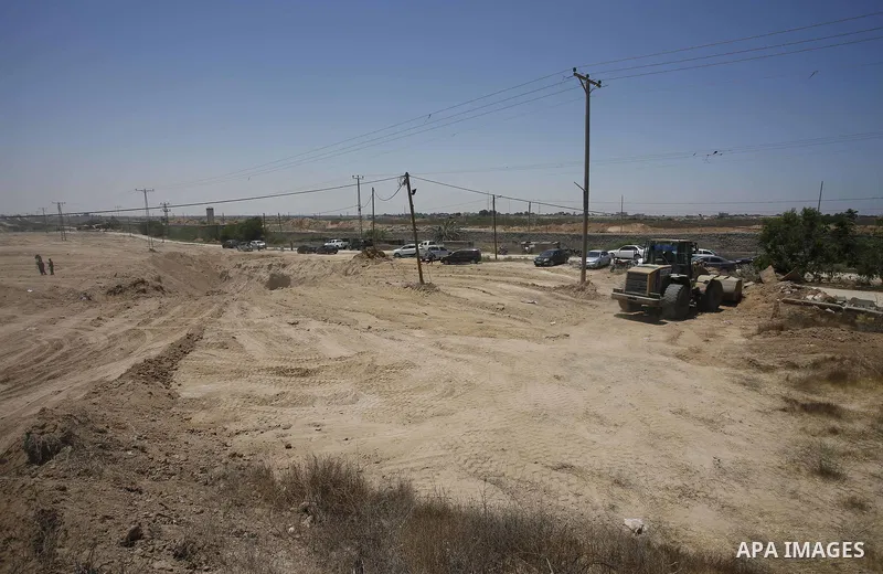 Palestinian bulldozers clear an area as Hamas begins creating a large buffer zone on the border with Egypt in the southern Gaza strip town of Rafah, on June 28, 2017. The buffer zone is expected to extend for a length of...
