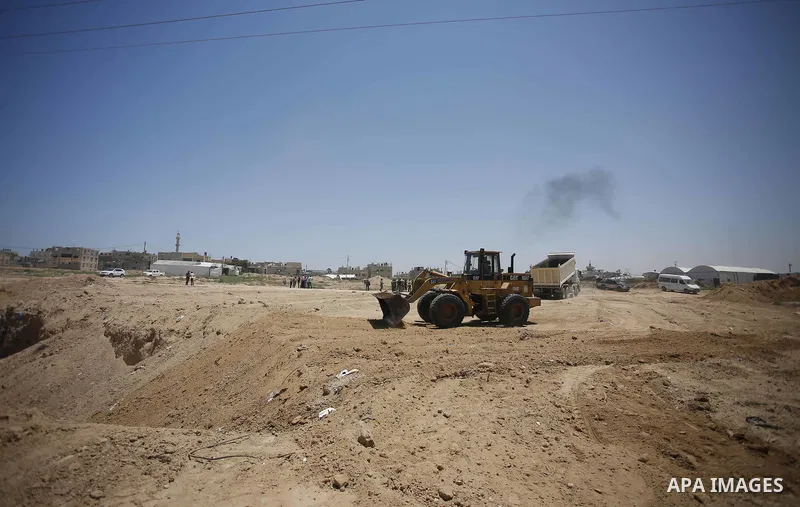 Palestinian bulldozers clear an area as Hamas begins creating a large buffer zone on the border with Egypt in the southern Gaza strip town of Rafah, on June 28, 2017. The buffer zone is expected to extend for a length of...