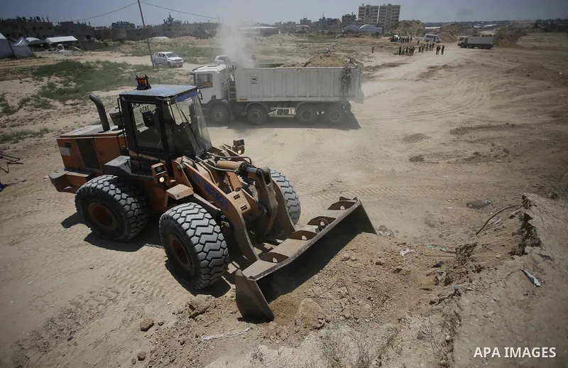 Palestinian bulldozers clear an area as Hamas begins creating a large buffer zone on the border with Egypt in the southern Gaza strip town of Rafah, on June 28, 2017. The buffer zone is expected to extend for a length of...