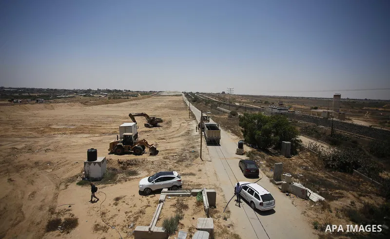 Palestinian bulldozers clear an area as Hamas begins creating a large buffer zone on the border with Egypt in the southern Gaza strip town of Rafah, on June 28, 2017. The buffer zone is expected to extend for a length of...