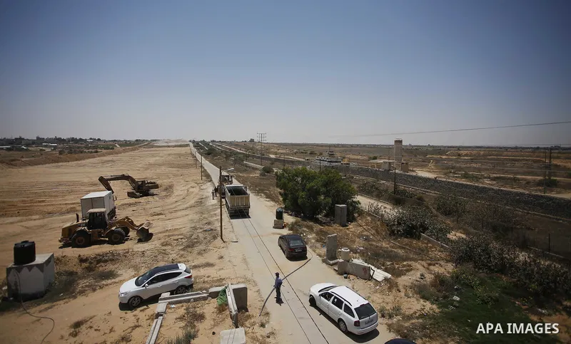 Palestinian bulldozers clear an area as Hamas begins creating a large buffer zone on the border with Egypt in the southern Gaza strip town of Rafah, on June 28, 2017. The buffer zone is expected to extend for a length of...
