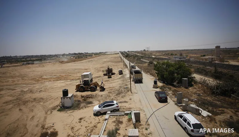 Palestinian bulldozers clear an area as Hamas begins creating a large buffer zone on the border with Egypt in the southern Gaza strip town of Rafah, on June 28, 2017. The buffer zone is expected to extend for a length of...