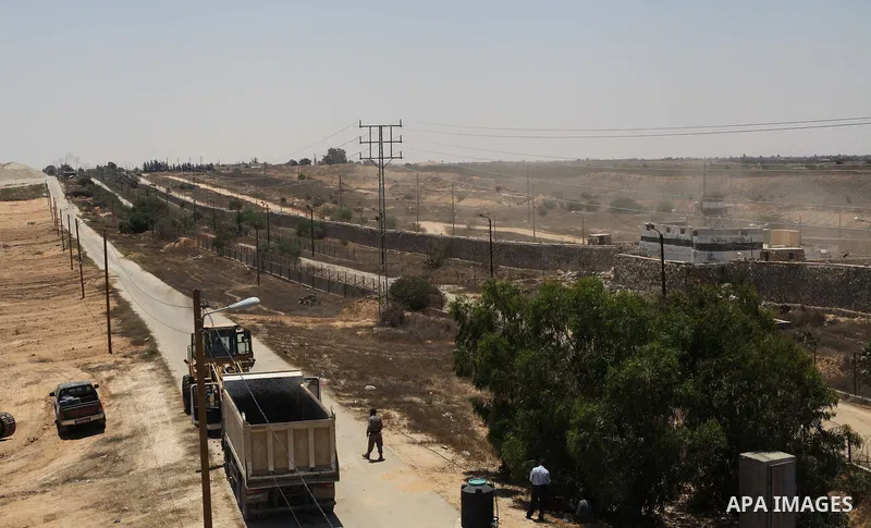 Palestinian bulldozers clear an area as Hamas begins creating a large buffer zone on the border with Egypt in the southern Gaza strip town of Rafah, on June 28, 2017. The buffer zone is expected to extend for a length of...