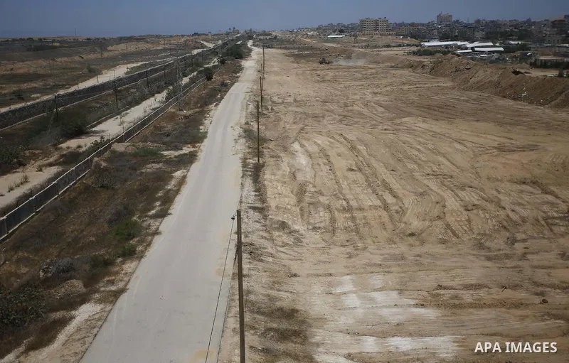 Palestinian bulldozers clear an area as Hamas begins creating a large buffer zone on the border with Egypt in the southern Gaza strip town of Rafah, on June 28, 2017. The buffer zone is expected to extend for a length of...
