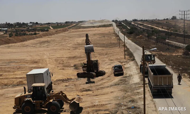 Palestinian bulldozers clear an area as Hamas begins creating a large buffer zone on the border with Egypt in the southern Gaza strip town of Rafah, on June 28, 2017. The buffer zone is expected to extend for a length of...