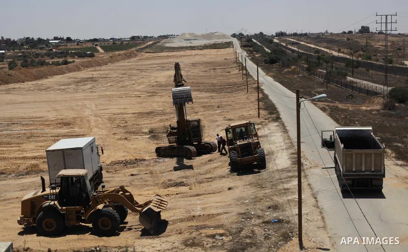Palestinian bulldozers clear an area as Hamas begins creating a large buffer zone on the border with Egypt in the southern Gaza strip town of Rafah, on June 28, 2017. The buffer zone is expected to extend for a length of...
