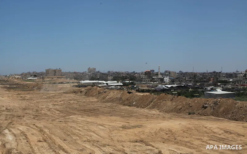 Palestinian bulldozers clear an area as Hamas begins creating a large buffer zone on the border with Egypt in the southern Gaza strip town of Rafah, on June 28, 2017. The buffer zone is expected to extend for a length of...