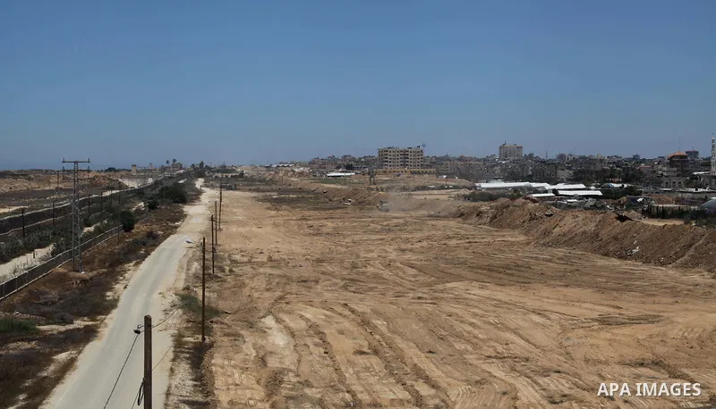 Palestinian bulldozers clear an area as Hamas begins creating a large buffer zone on the border with Egypt in the southern Gaza strip town of Rafah, on June 28, 2017. The buffer zone is expected to extend for a length of...