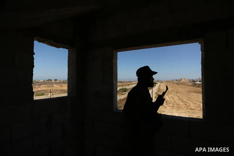 A member of Palestinian security forces stands guard during patrol a section of the border with Egypt, in the southern Gaza strip town of Rafah, on June 29, 2017. The buffer zone is expected to extend for a length of 12...