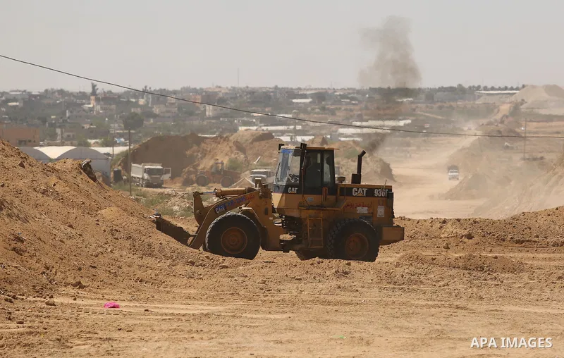 Parliment Palestinian bulldozers clear an area as Hamas begins creating a large buffer zone on the border with Egypt in the southern Gaza strip town of Rafah, on June 29, 2017. The buffer zone is expected to extend for a...