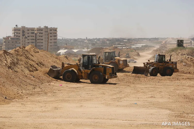 Parliment Palestinian bulldozers clear an area as Hamas begins creating a large buffer zone on the border with Egypt in the southern Gaza strip town of Rafah, on June 29, 2017. The buffer zone is expected to extend for a...