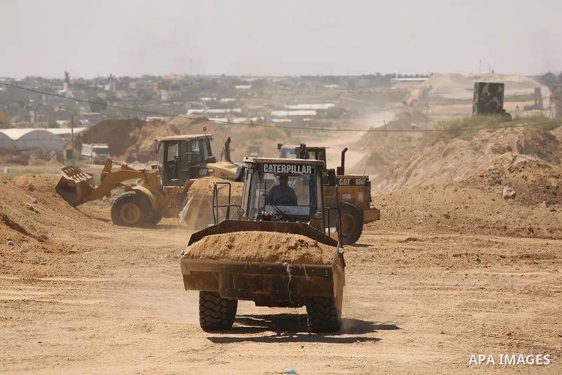 Parliment Palestinian bulldozers clear an area as Hamas begins creating a large buffer zone on the border with Egypt in the southern Gaza strip town of Rafah, on June 29, 2017. The buffer zone is expected to extend for a...