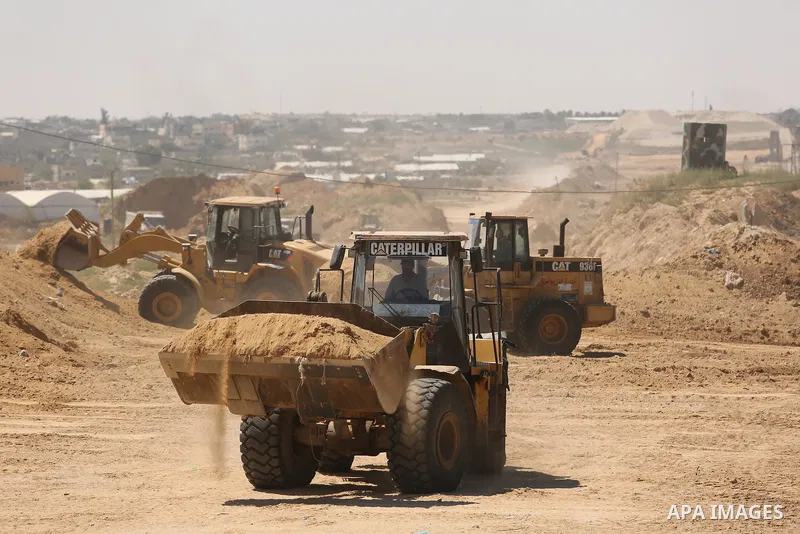 Parliment Palestinian bulldozers clear an area as Hamas begins creating a large buffer zone on the border with Egypt in the southern Gaza strip town of Rafah, on June 29, 2017. The buffer zone is expected to extend for a...