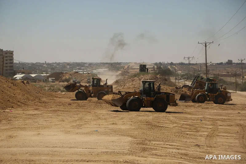 Parliment Palestinian bulldozers clear an area as Hamas begins creating a large buffer zone on the border with Egypt in the southern Gaza strip town of Rafah, on June 29, 2017. The buffer zone is expected to extend for a...