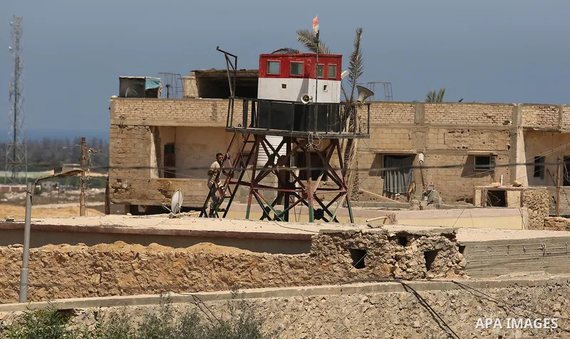 An Egyptian border stands guard on the border with Egypt, in the southern Gaza strip town of Rafah, on June 29, 2017. The buffer zone is expected to extend for a length of 12 kilometres and at a width of 100 metres along...