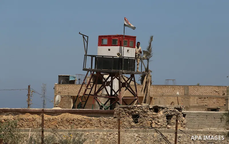 An Egyptian border stands guard on the border with Egypt, in the southern Gaza strip town of Rafah, on June 29, 2017. The buffer zone is expected to extend for a length of 12 kilometres and at a width of 100 metres along...