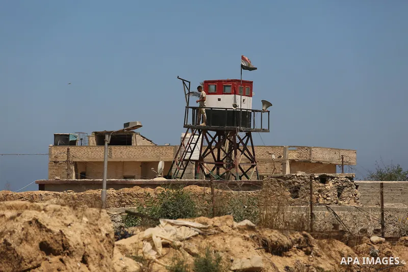 An Egyptian border stands guard on the border with Egypt, in the southern Gaza strip town of Rafah, on June 29, 2017. The buffer zone is expected to extend for a length of 12 kilometres and at a width of 100 metres along...