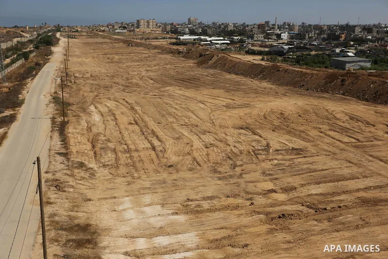 Parliment Palestinian bulldozers clear an area as Hamas begins creating a large buffer zone on the border with Egypt in the southern Gaza strip town of Rafah, on June 29, 2017. The buffer zone is expected to extend for a...