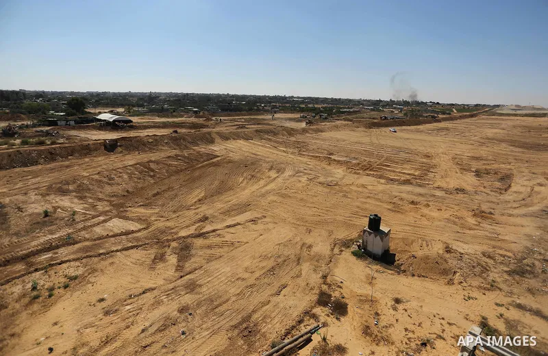 Parliment Palestinian bulldozers clear an area as Hamas begins creating a large buffer zone on the border with Egypt in the southern Gaza strip town of Rafah, on June 29, 2017. The buffer zone is expected to extend for a...