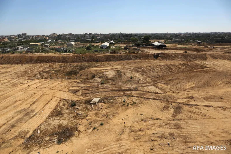 Parliment Palestinian bulldozers clear an area as Hamas begins creating a large buffer zone on the border with Egypt in the southern Gaza strip town of Rafah, on June 29, 2017. The buffer zone is expected to extend for a...