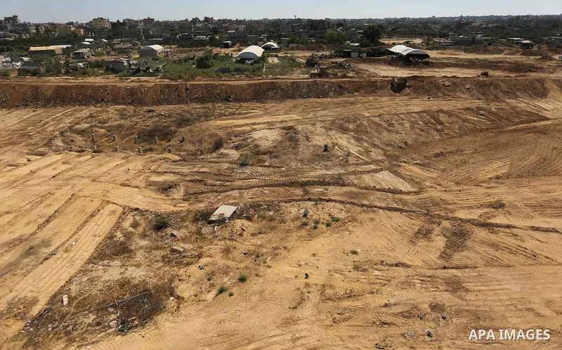 Parliment Palestinian bulldozers clear an area as Hamas begins creating a large buffer zone on the border with Egypt in the southern Gaza strip town of Rafah, on June 29, 2017. The buffer zone is expected to extend for a...