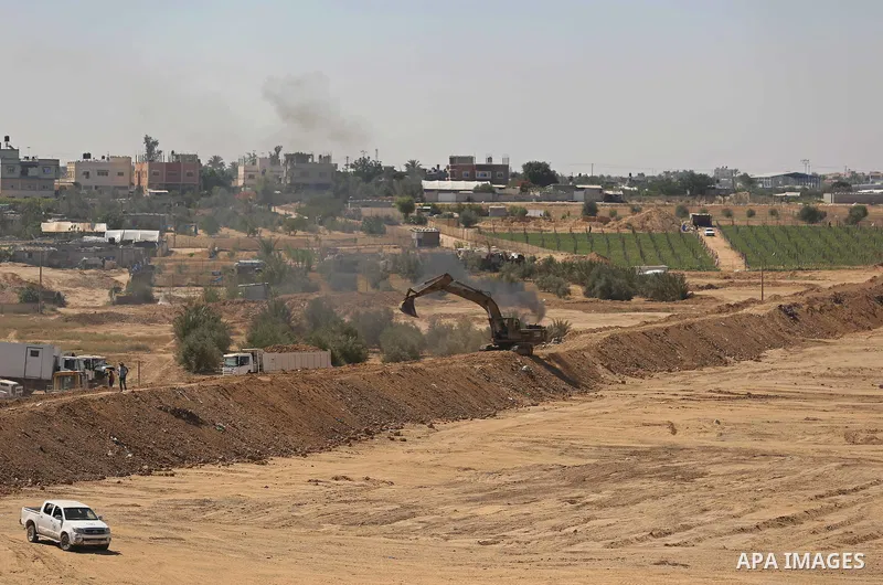 Parliment Palestinian bulldozers clear an area as Hamas begins creating a large buffer zone on the border with Egypt in the southern Gaza strip town of Rafah, on June 29, 2017. The buffer zone is expected to extend for a...