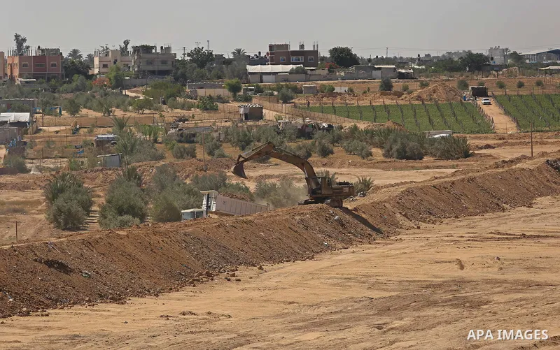 Parliment Palestinian bulldozers clear an area as Hamas begins creating a large buffer zone on the border with Egypt in the southern Gaza strip town of Rafah, on June 29, 2017. The buffer zone is expected to extend for a...