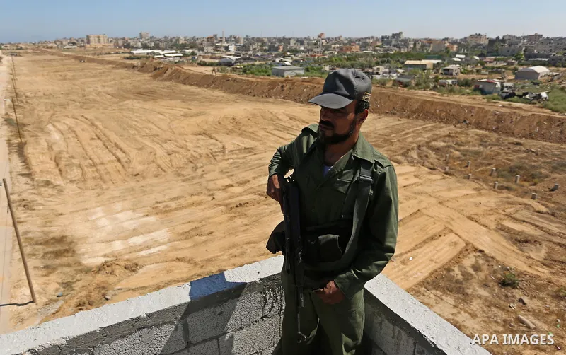 A member of Palestinian security forces stands guard during patrol a section of the border with Egypt, in the southern Gaza strip town of Rafah, on June 29, 2017. The buffer zone is expected to extend for a length of 12...