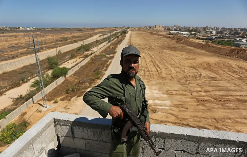 A member of Palestinian security forces stands guard during patrol a section of the border with Egypt, in the southern Gaza strip town of Rafah, on June 29, 2017. The buffer zone is expected to extend for a length of 12...