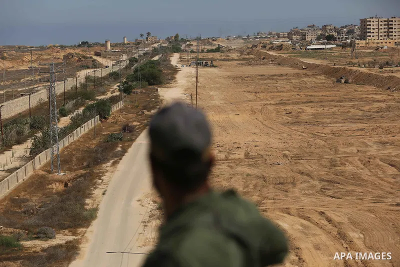 A member of Palestinian security forces stands guard during patrol a section of the border with Egypt, in the southern Gaza strip town of Rafah, on June 29, 2017. The buffer zone is expected to extend for a length of 12...