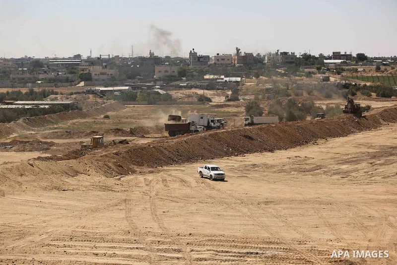 Parliment Palestinian bulldozers clear an area as Hamas begins creating a large buffer zone on the border with Egypt in the southern Gaza strip town of Rafah, on June 29, 2017. The buffer zone is expected to extend for a...