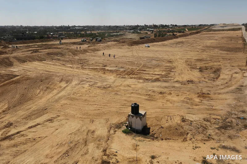 Parliment Palestinian bulldozers clear an area as Hamas begins creating a large buffer zone on the border with Egypt in the southern Gaza strip town of Rafah, on June 29, 2017. The buffer zone is expected to extend for a...
