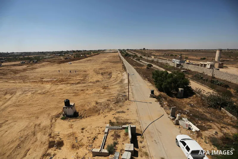 Parliment Palestinian bulldozers clear an area as Hamas begins creating a large buffer zone on the border with Egypt in the southern Gaza strip town of Rafah, on June 29, 2017. The buffer zone is expected to extend for a...