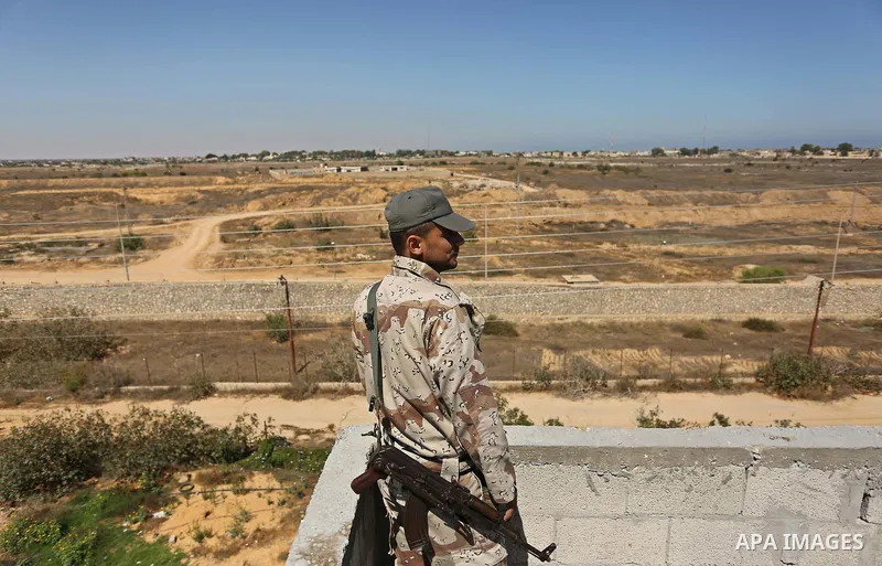 An Egyptian border stands guard on the border with Egypt, in the southern Gaza strip town of Rafah, on June 29, 2017. The buffer zone is expected to extend for a length of 12 kilometres and at a width of 100 metres along...