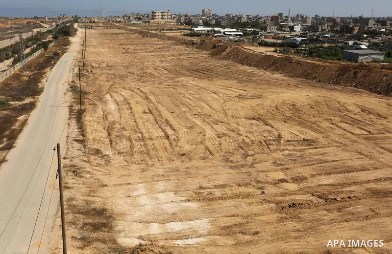 Parliment Palestinian bulldozers clear an area as Hamas begins creating a large buffer zone on the border with Egypt in the southern Gaza strip town of Rafah, on June 29, 2017. The buffer zone is expected to extend for a...