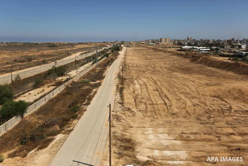 Parliment Palestinian bulldozers clear an area as Hamas begins creating a large buffer zone on the border with Egypt in the southern Gaza strip town of Rafah, on June 29, 2017. The buffer zone is expected to extend for a...