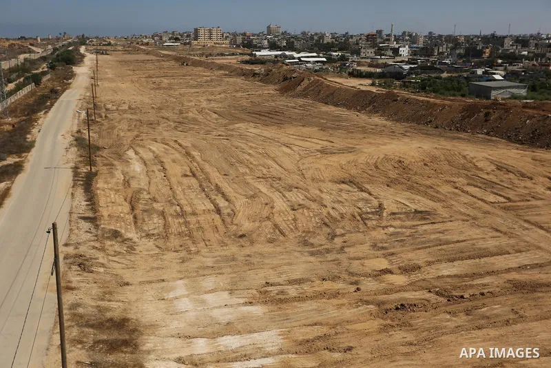 Parliment Palestinian bulldozers clear an area as Hamas begins creating a large buffer zone on the border with Egypt in the southern Gaza strip town of Rafah, on June 29, 2017. The buffer zone is expected to extend for a...