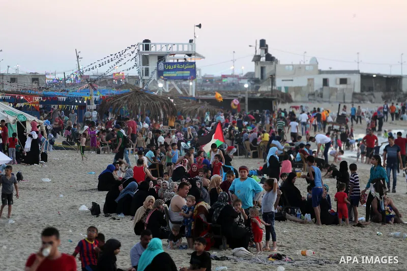 Palestinians enjoy thier time during the sunset on the beach of Gaza city, on June 29, 2017. Photo by Mohammed Asad
