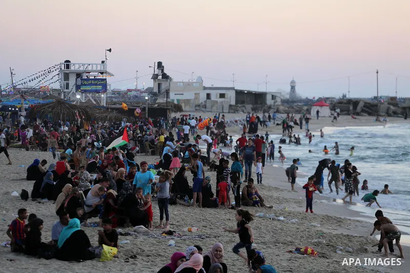 Palestinians enjoy thier time during the sunset on the beach of Gaza city, on June 29, 2017. Photo by Mohammed Asad