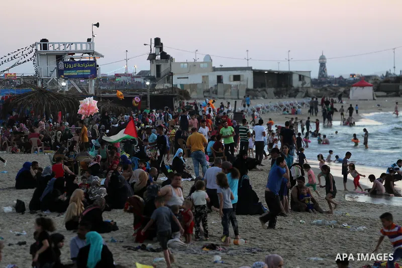 Palestinians enjoy thier time during the sunset on the beach of Gaza city, on June 29, 2017. Photo by Mohammed Asad