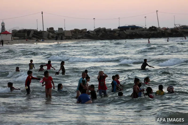 Palestinians enjoy thier time during the sunset on the beach of Gaza city, on June 29, 2017. Photo by Mohammed Asad