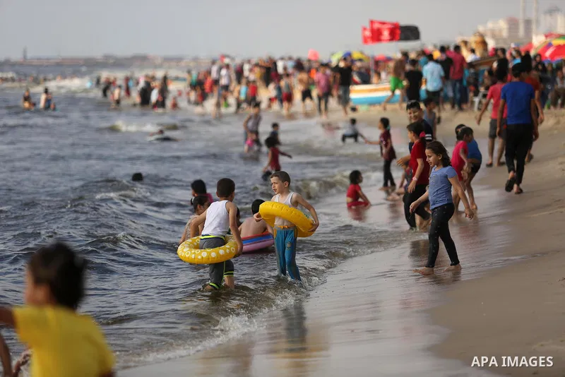 Palestinians enjoy their time at the beach of the Mediterranean sea on the coast of Gaza city, on June 30, 2017. Photo by Ashraf Amra