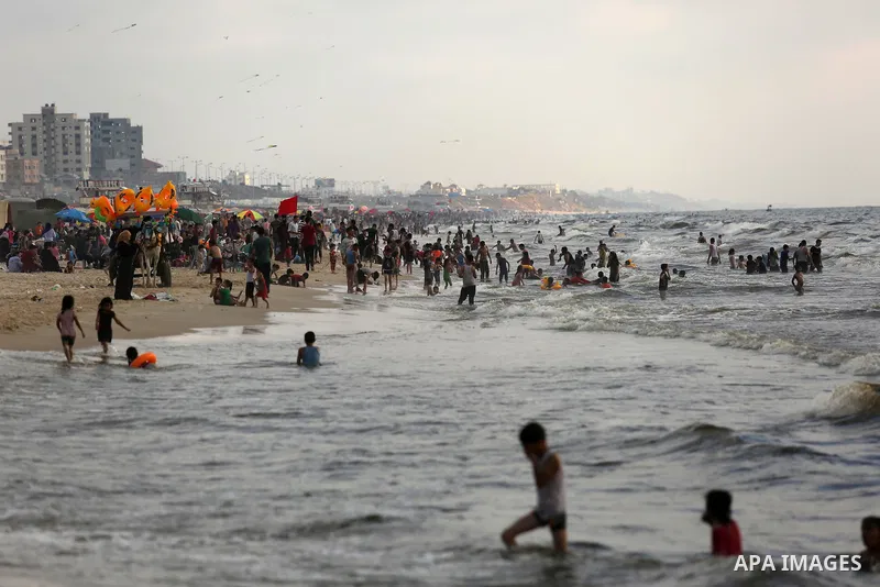 Palestinians enjoy their time at the beach of the Mediterranean sea on the coast of Gaza city, on June 30, 2017. Photo by Ashraf Amra