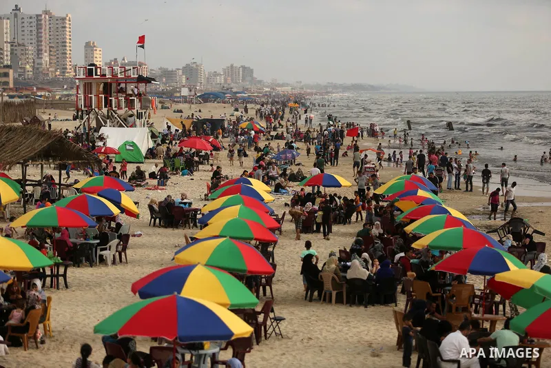 Palestinians enjoy their time at the beach of the Mediterranean sea on the coast of Gaza city, on June 30, 2017. Photo by Ashraf Amra